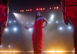 Photo of Tracee Ellis Ross on stage in red jumpsuit as Grace Davis. Tracee Ellis Ross stars as Grace Davis in THE HIGH NOTE, a Focus Features release. Credit: Glen Wilson / Focus Features